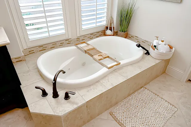 a living room with furniture a flat screen tv and kitchen view