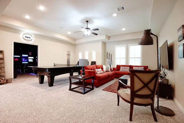 a room with lots of furniture and view of living room