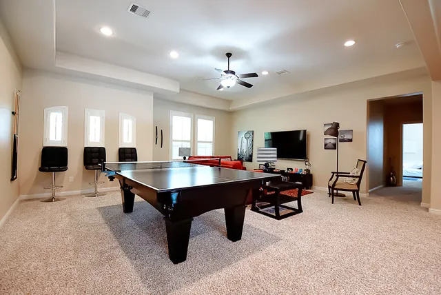 a living room with lots of chairs and a chandelier