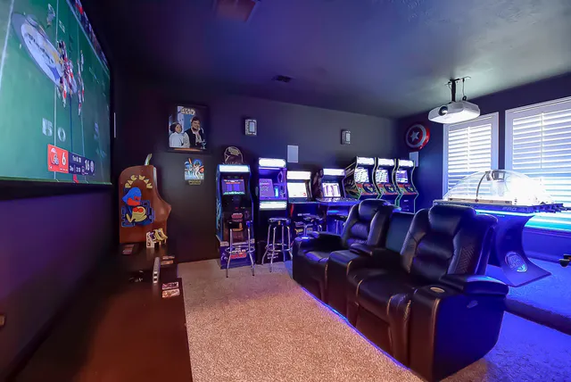 a room with furniture projector and screen