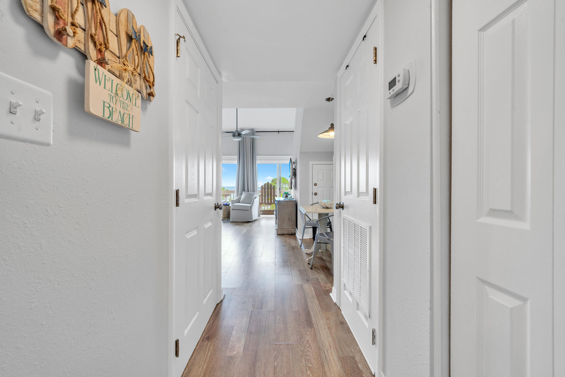145 Beachfront Trail, Unit 303A Santa Rosa Beach, FL 32459 - Photo 12 of 38 a view of hallway with livingroom and wooden floor