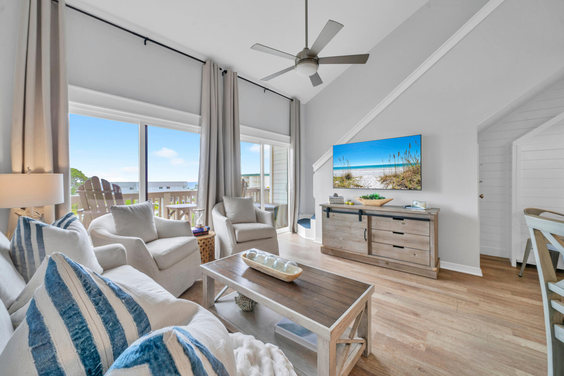145 Beachfront Trail, Unit 303A Santa Rosa Beach, FL 32459 - Photo 3 of 38 a living room with furniture a flat screen tv and floor to ceiling window