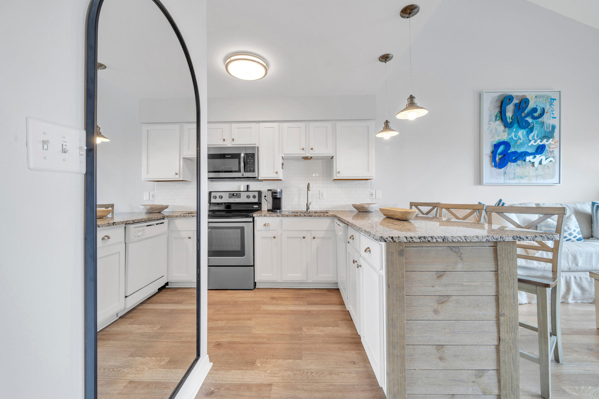 145 Beachfront Trail, Unit 303A Santa Rosa Beach, FL 32459 - Photo 6 of 38 a kitchen with granite countertop a stove top oven and cabinets