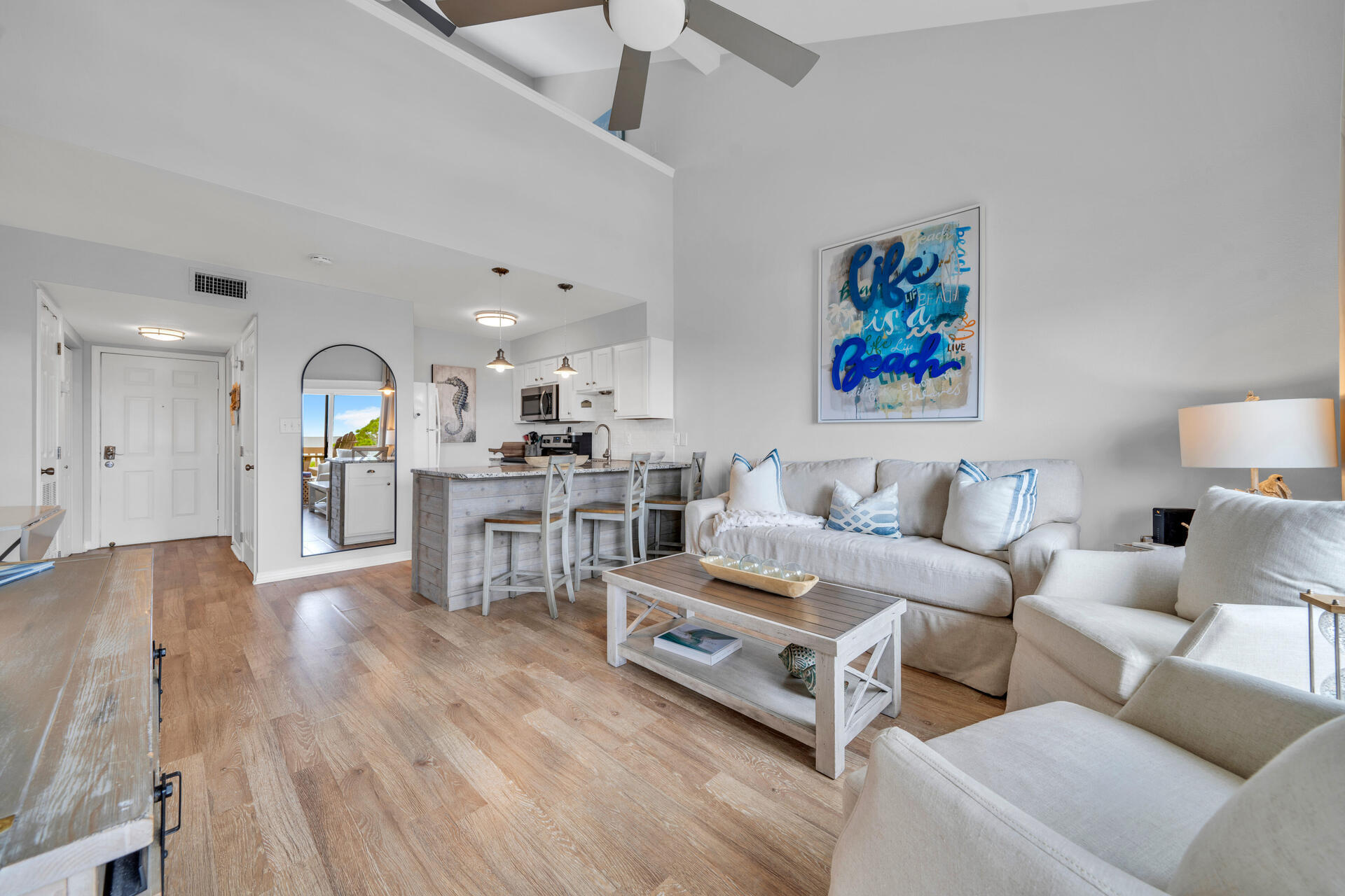 145 Beachfront Trail, Unit 303A Santa Rosa Beach, FL 32459 - Photo 10 of 38 a living room with furniture and a wooden floor