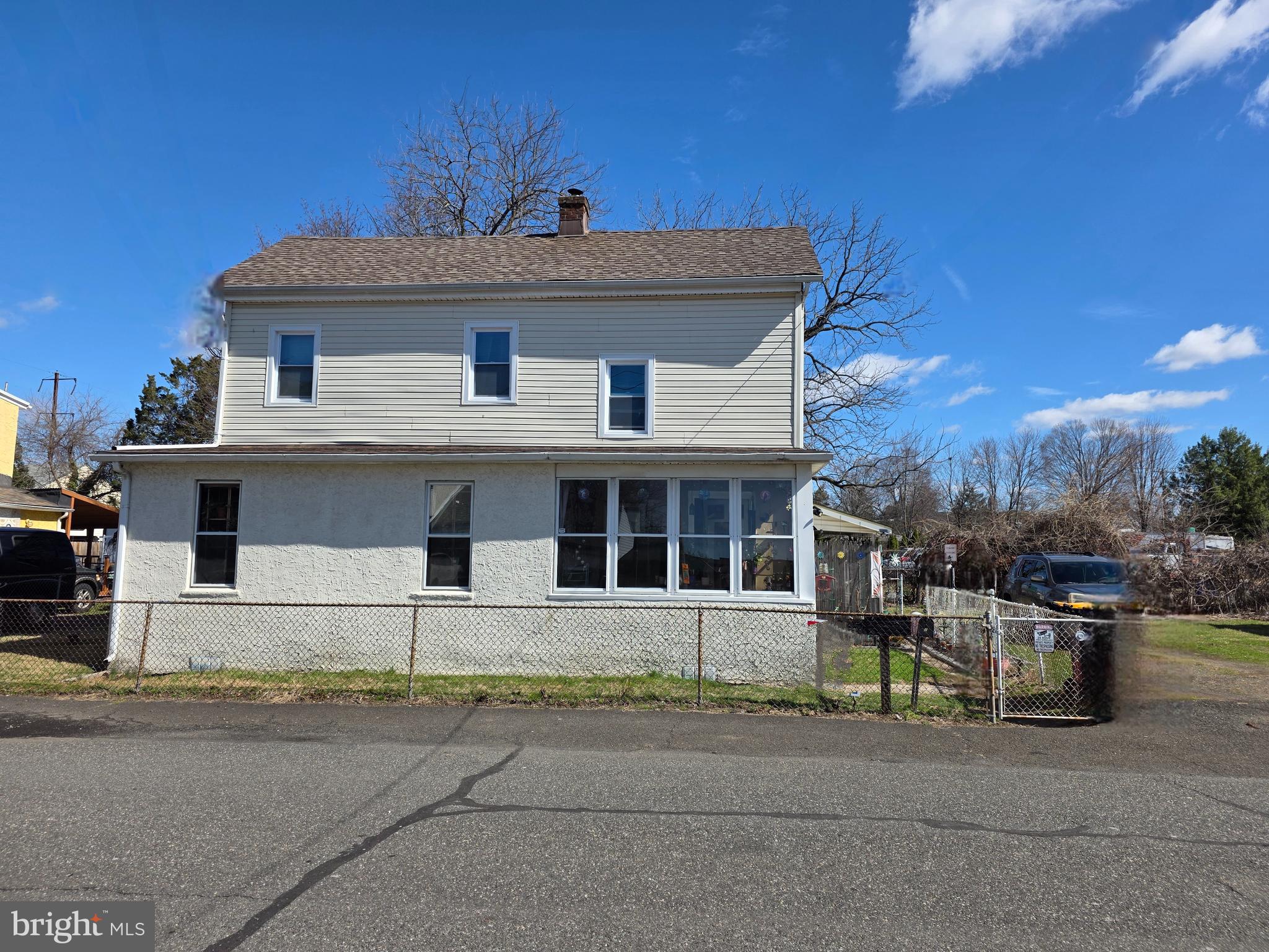 732 Brown Street Tullytown, PA 19007 - Photo 5 of 6 a front view of a house with a garden and parking