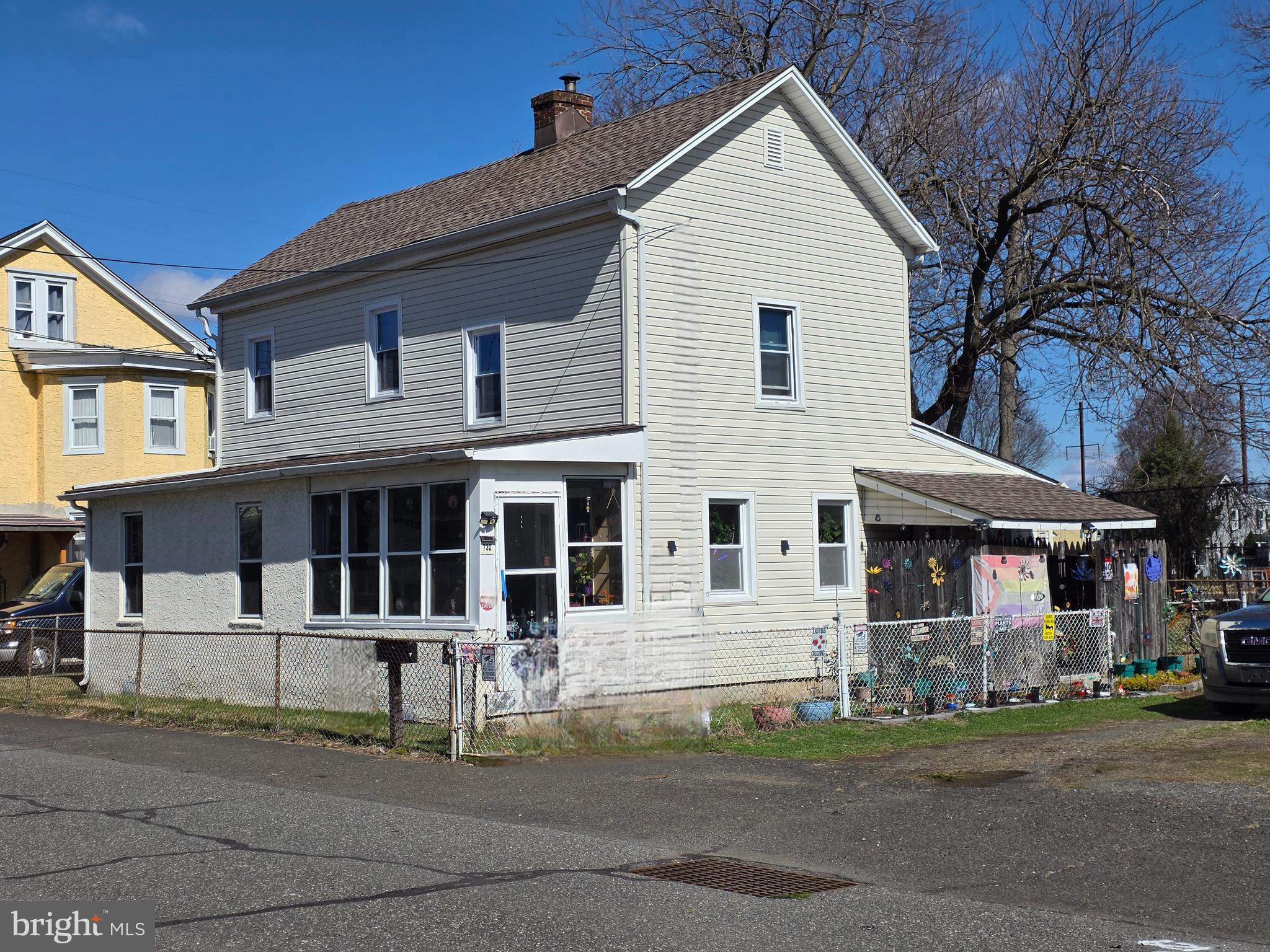 732 Brown Street Tullytown, PA 19007 - Photo 6 of 6 a view of a white house with large windows and a table and chairs
