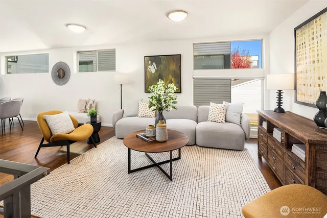 a living room with furniture and a potted plant