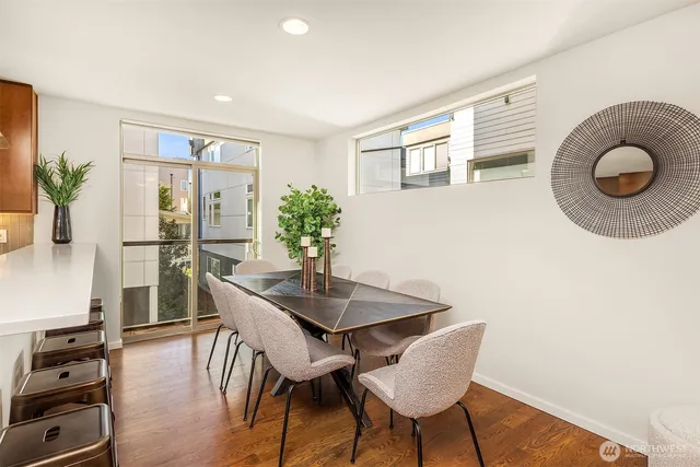 a view of a dining room with furniture and wooden floor