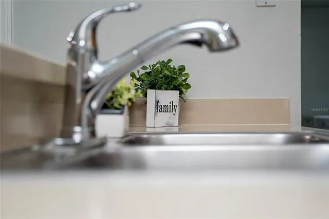 a kitchen with a sink and refrigerator