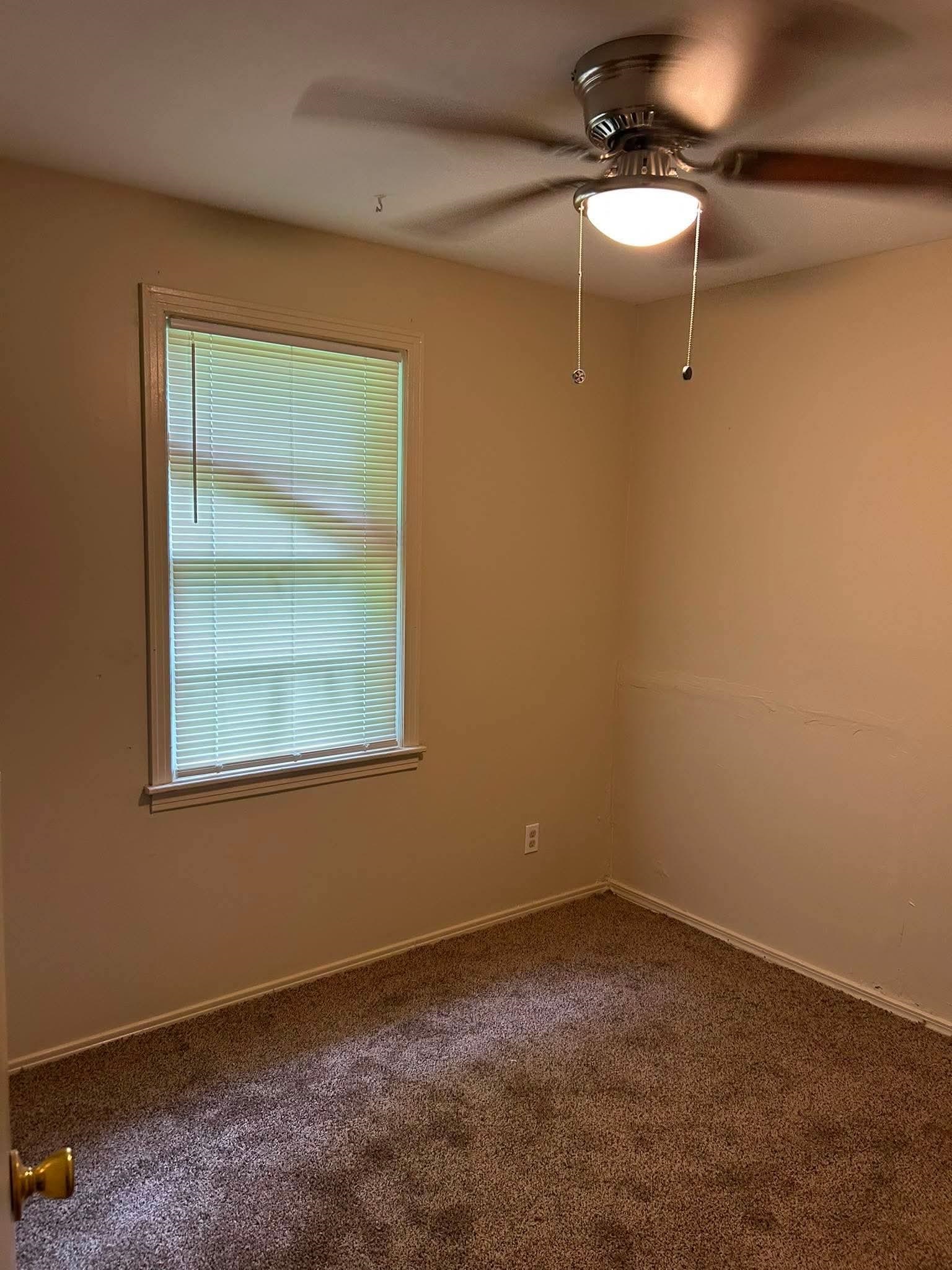 1510 Gausco Road Memphis, TN 38106 - Photo 5 of 10 Neutral-toned walls complement the brown carpeted flooring