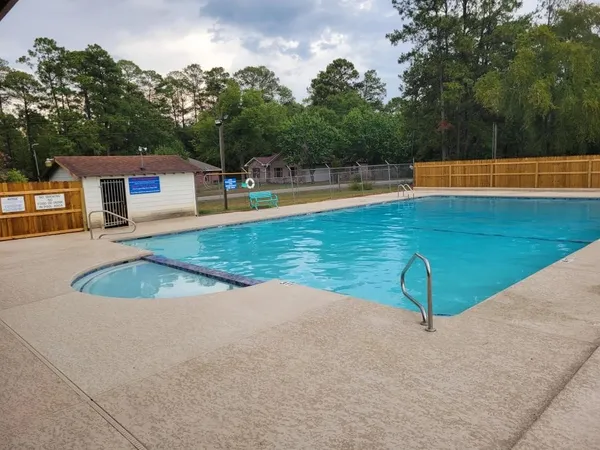 a view of a swimming pool with an outdoor space and seating area