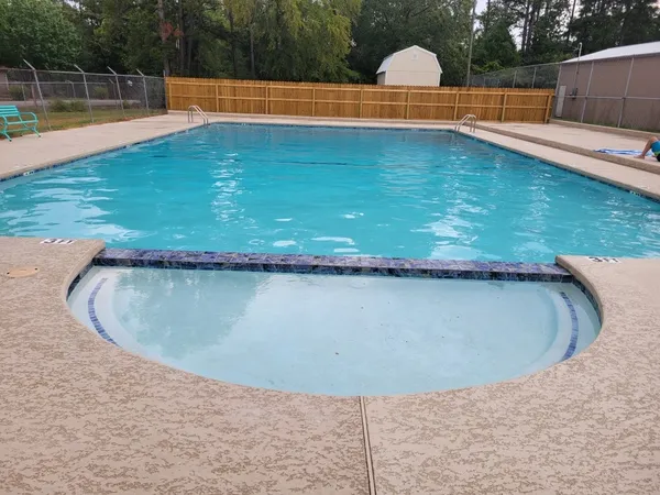 a view of a swimming pool with a yard