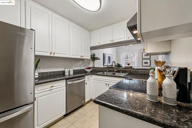 a kitchen sink with a granite countertop window