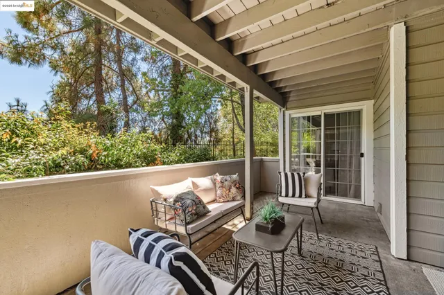 a balcony with furniture and a potted plant