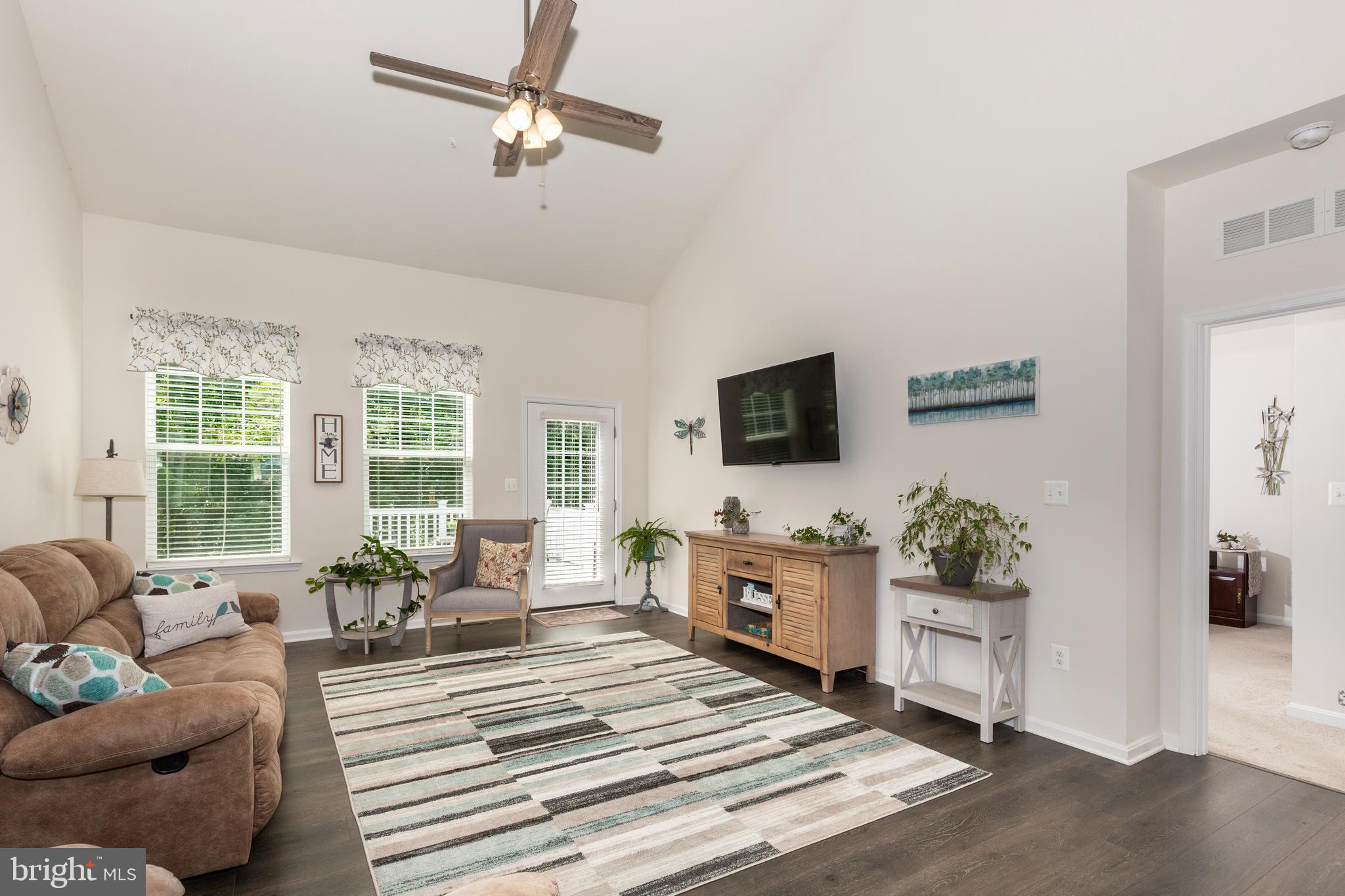 2910 Union Square Road, Unit 34 New Windsor, MD 21776 - Photo 13 of 49 a living room with furniture a flat screen tv and a fireplace