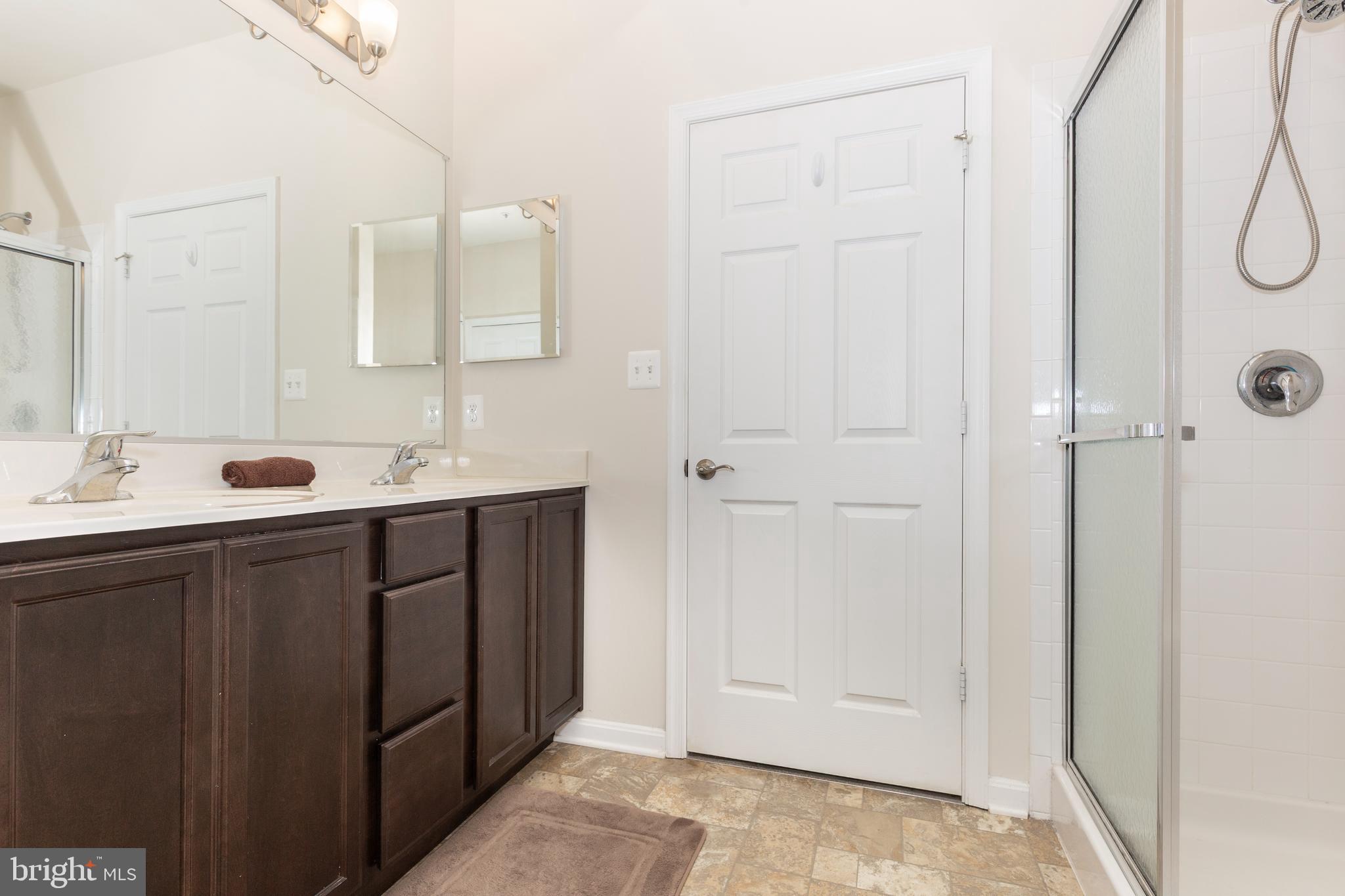 2910 Union Square Road, Unit 34 New Windsor, MD 21776 - Photo 21 of 49 a bathroom with a double vanity sink a mirror and shower