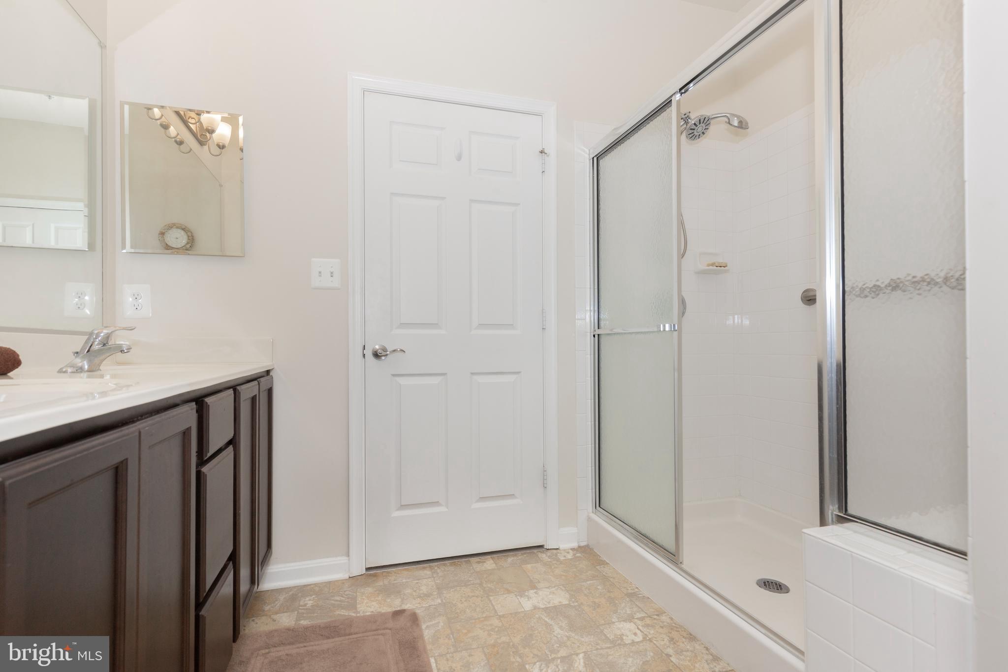 2910 Union Square Road, Unit 34 New Windsor, MD 21776 - Photo 23 of 49 a bathroom with a shower sink and vanity