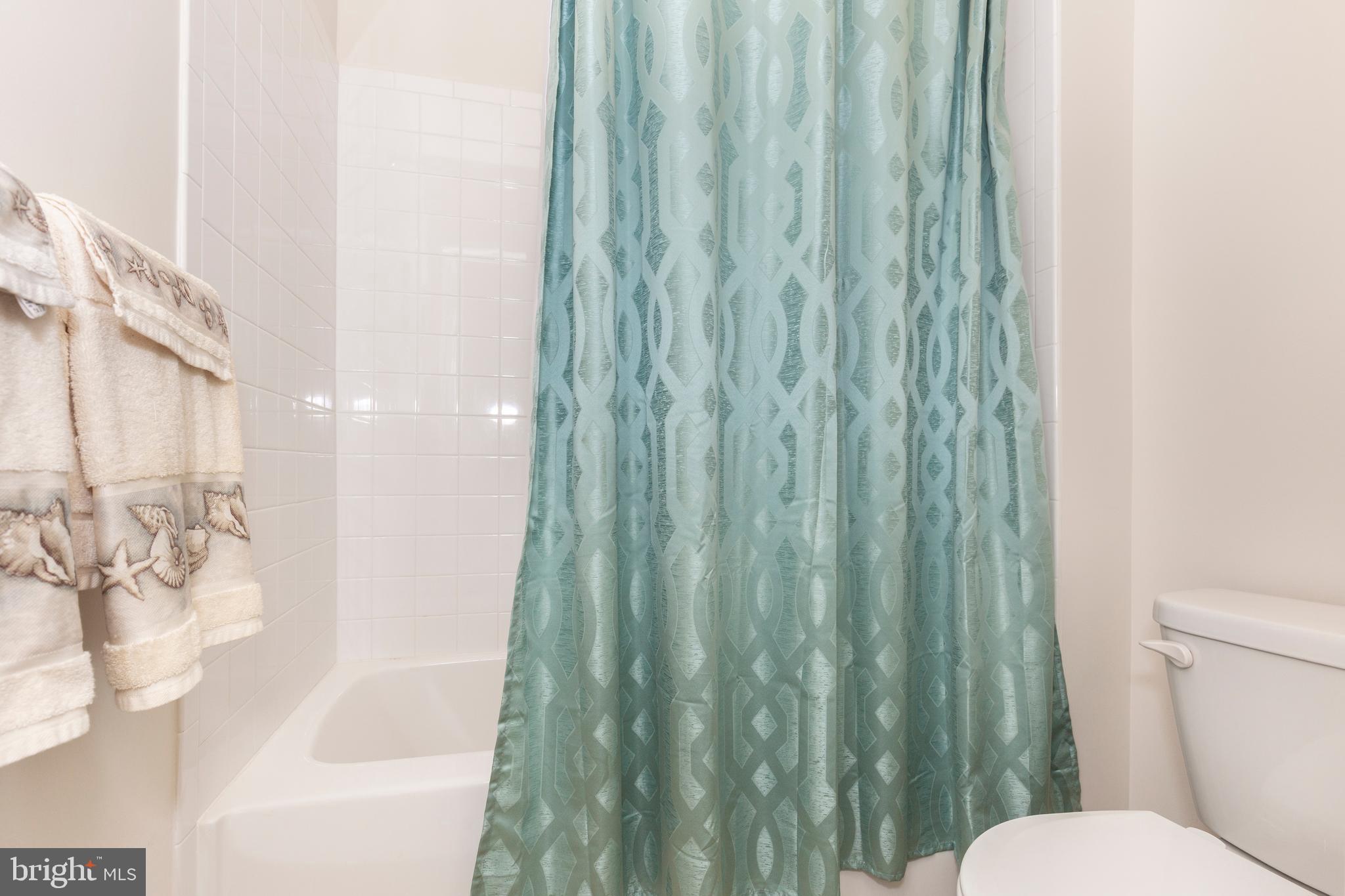 2910 Union Square Road, Unit 34 New Windsor, MD 21776 - Photo 35 of 49 a white toilet sitting next to a bathtub