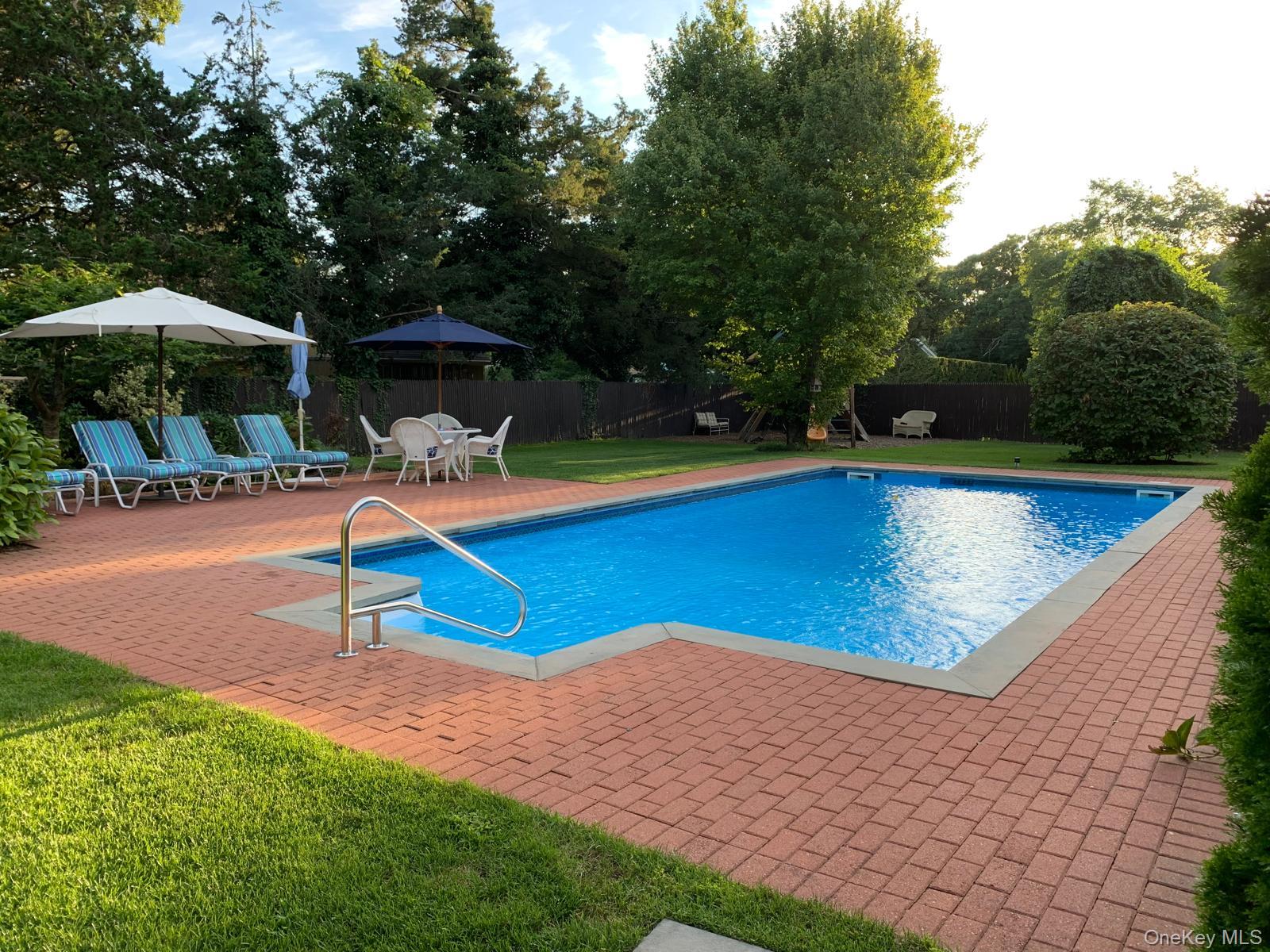 a view of a swimming pool with lounge chairs