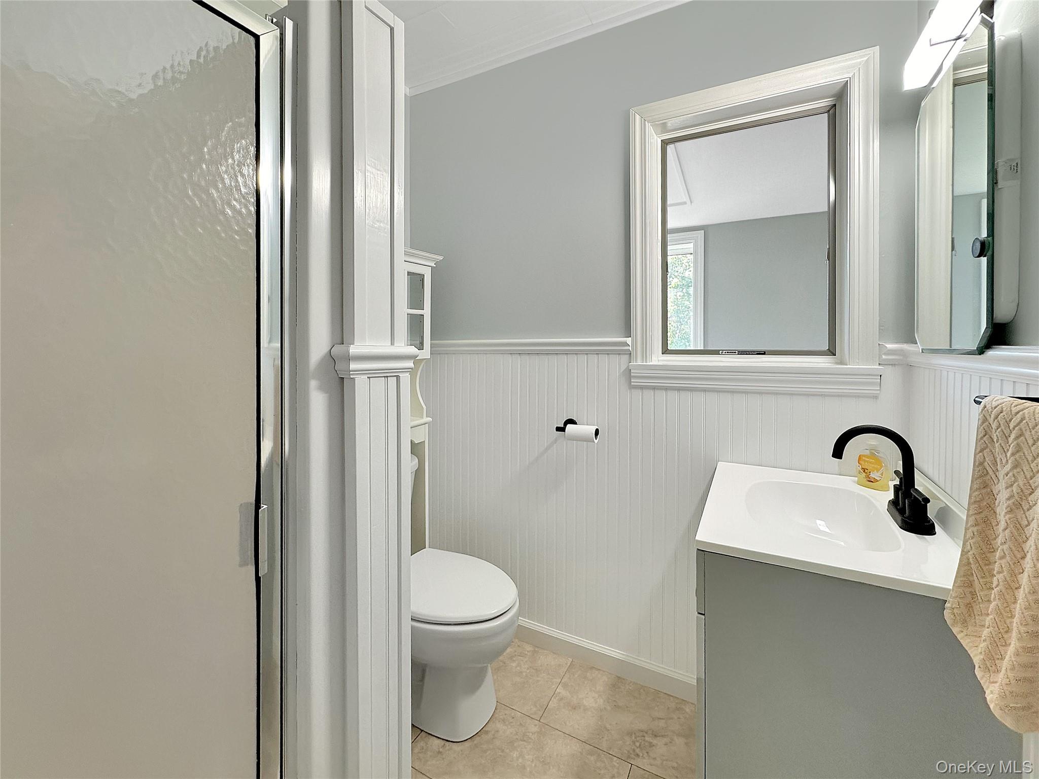 190 A Wakeman Road Hampton Bays, NY 11946 - Photo 16 of 17 a bathroom with a toilet sink and shower