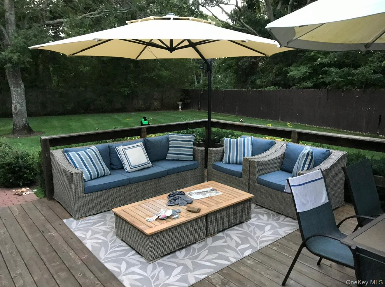 190 A Wakeman Road Hampton Bays, NY 11946 - Photo 17 of 18 a view of a patio with couches under an umbrella