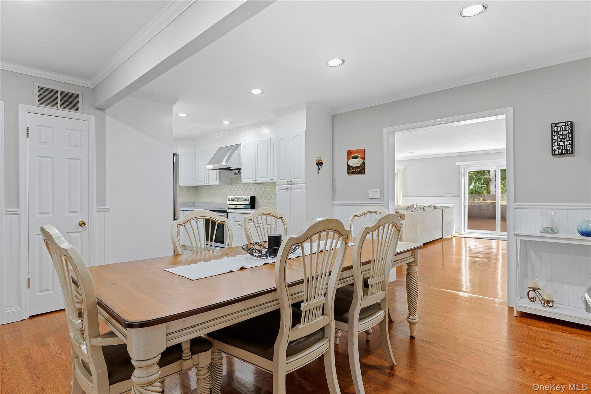 190 A Wakeman Road Hampton Bays, NY 11946 - Photo 6 of 17 a kitchen with a dining table chairs and wooden floor
