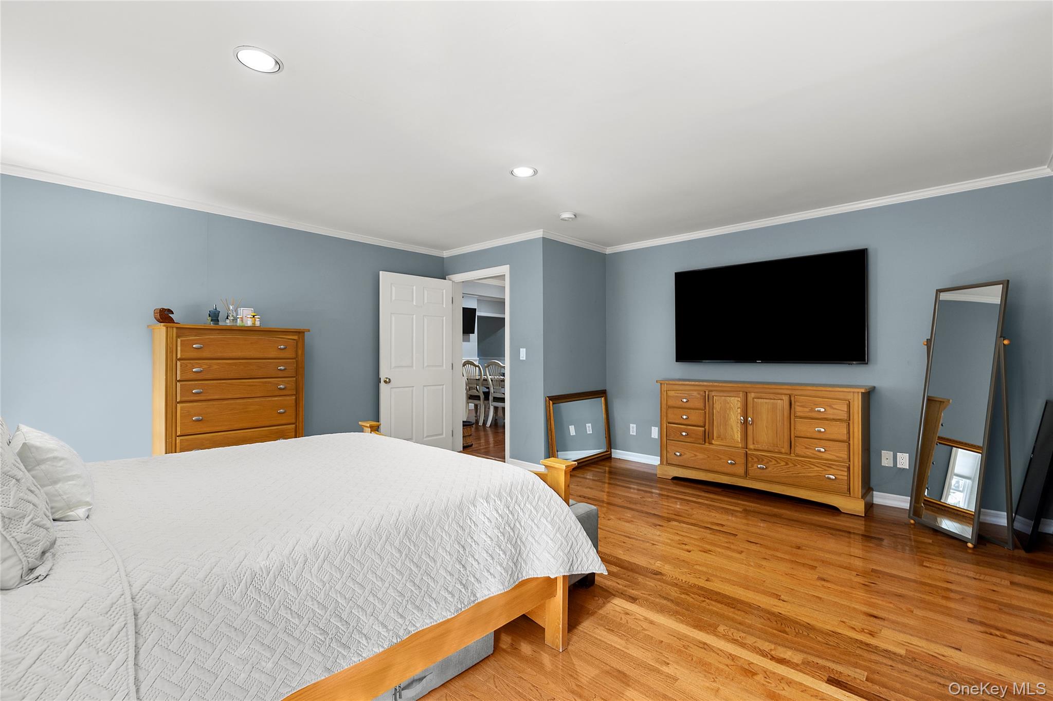 190 A Wakeman Road Hampton Bays, NY 11946 - Photo 8 of 17 a bedroom with a bed and a flat screen tv