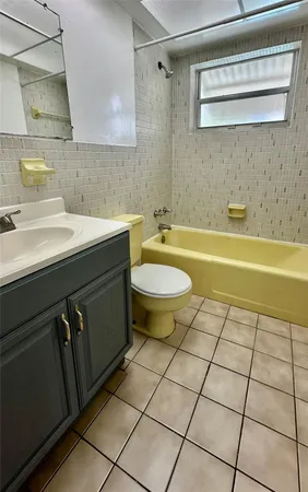 a bathroom with a sink a toilet and bathtub