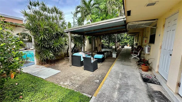 a view of a patio with table and chairs potted plants with wooden floor