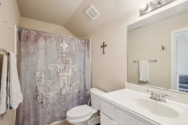 a bathroom with a toilet sink and a mirror