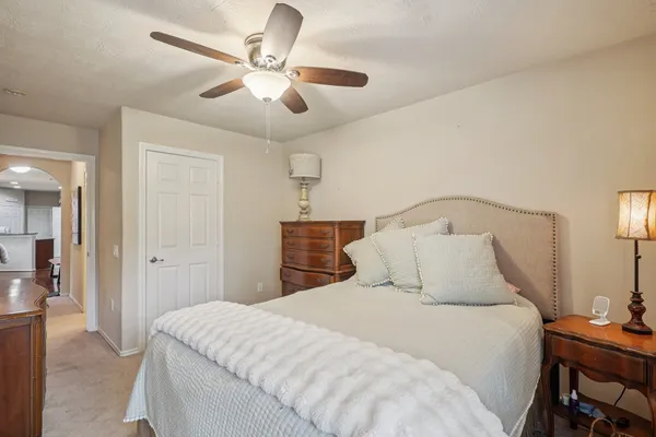 a living room with furniture and a ceiling fan