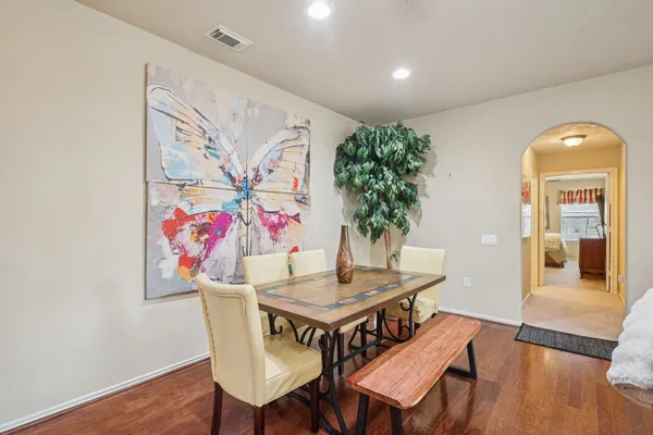 a view of a dining room with furniture and wooden floor