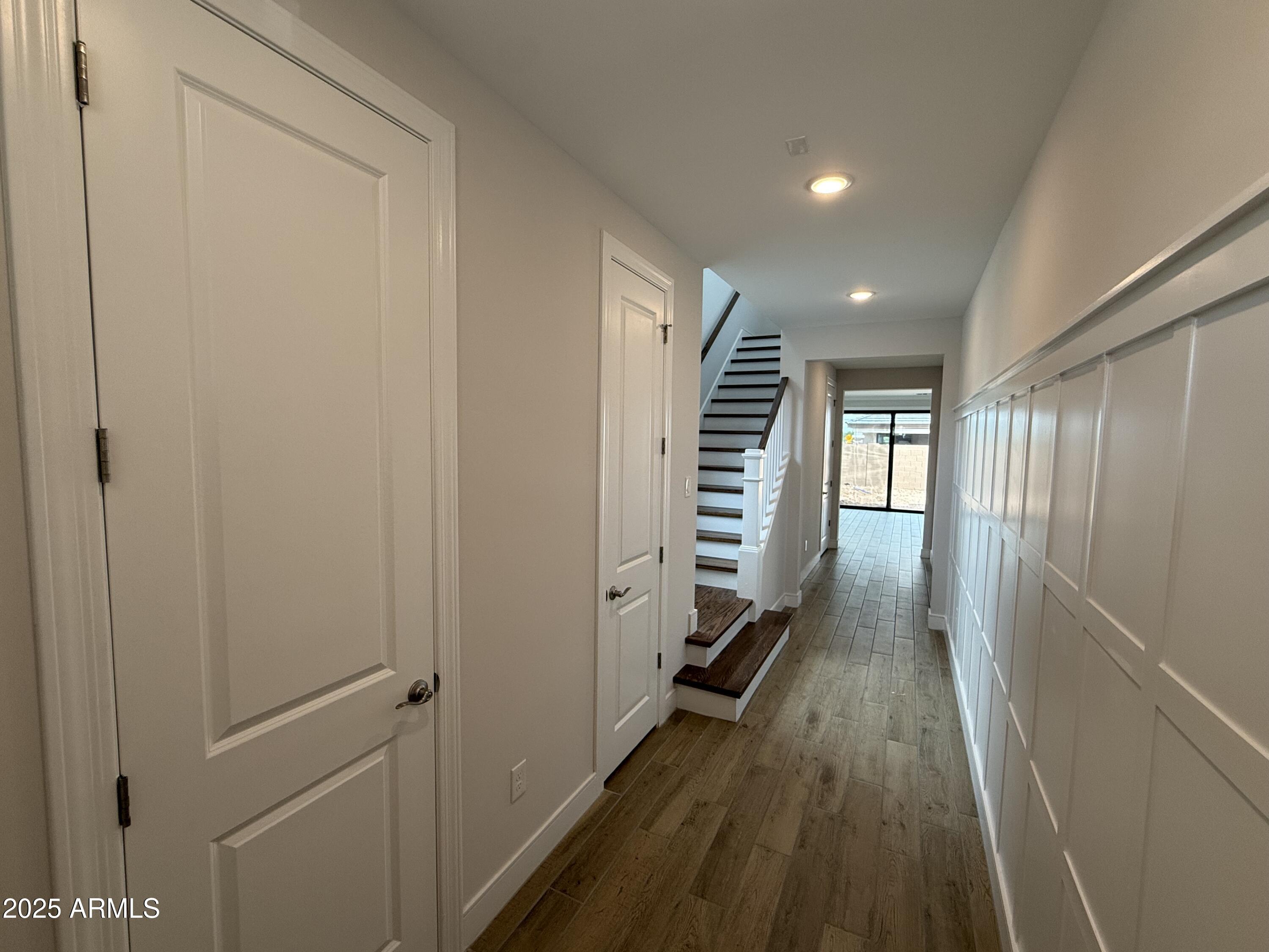2430 West Los Arboles Place Chandler, AZ 85224 - Photo 9 of 41 a view of a hallway with wooden floor and staircase