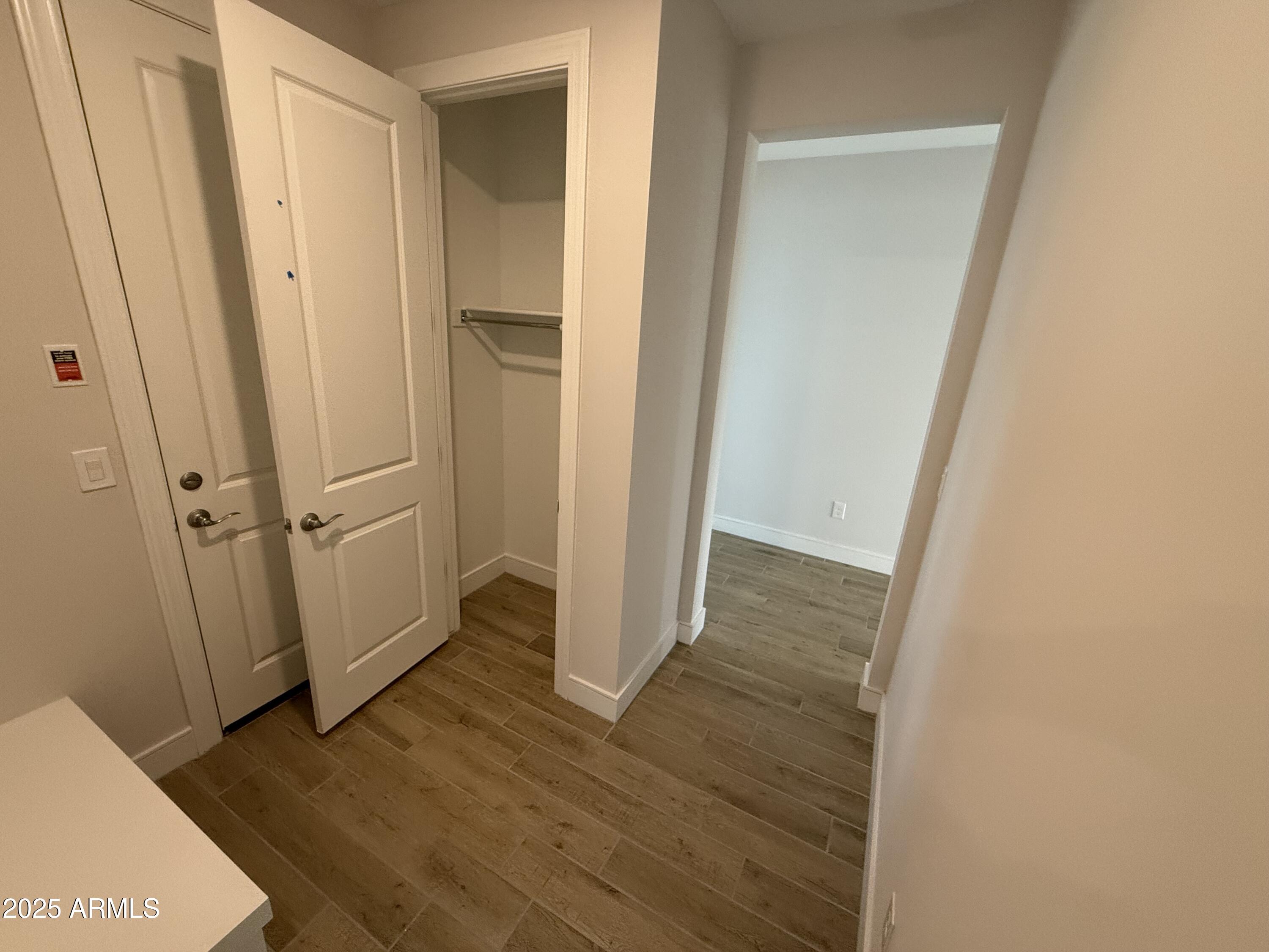 2430 West Los Arboles Place Chandler, AZ 85224 - Photo 12 of 41 a view of a hallway with wooden floor