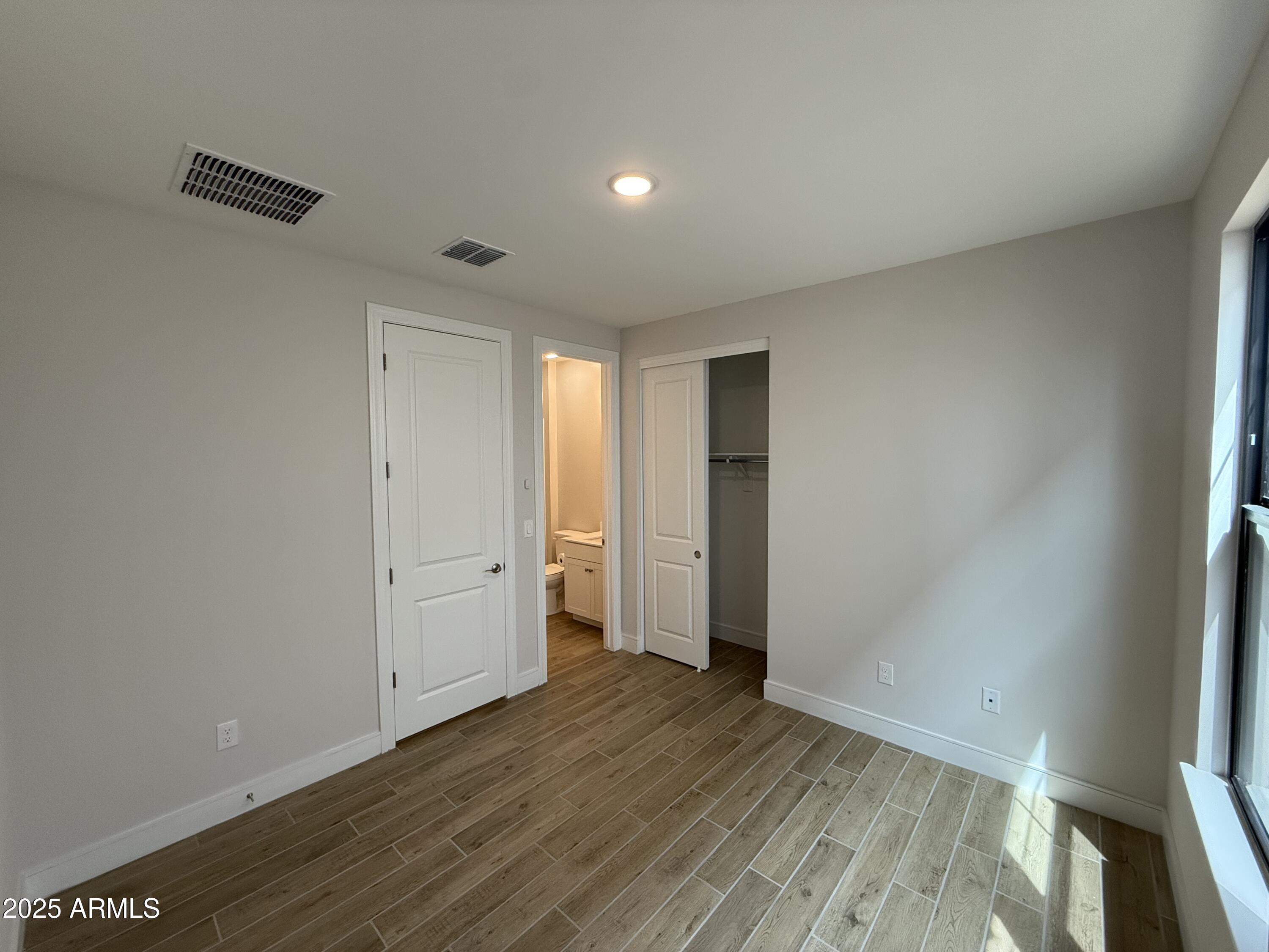 2430 West Los Arboles Place Chandler, AZ 85224 - Photo 16 of 41 a view of an empty room with wooden floor