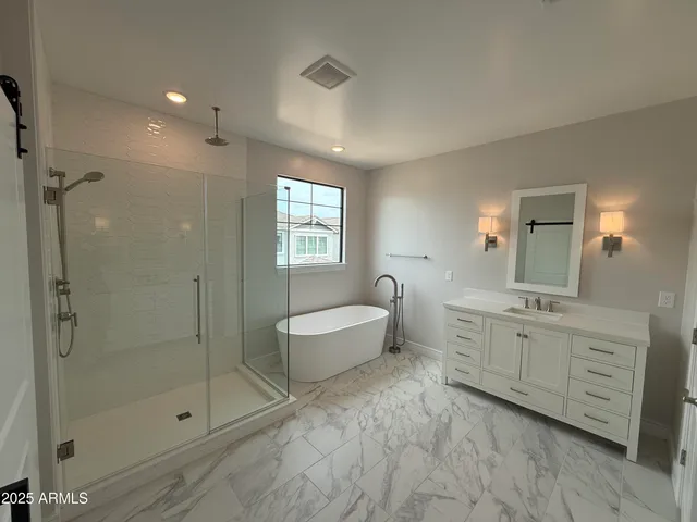 a spacious bathroom with a shower sink mirror and toilet