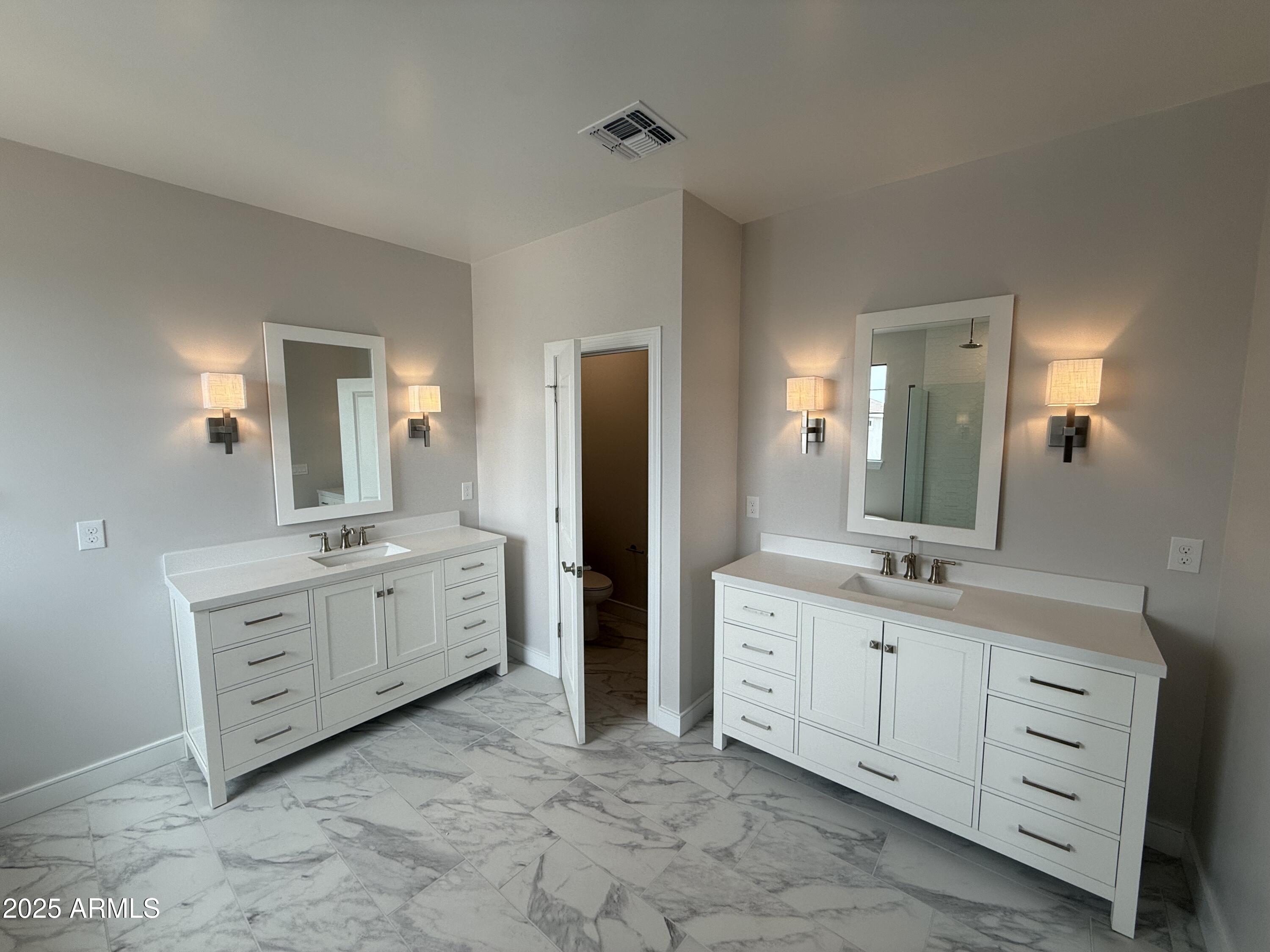 2430 West Los Arboles Place Chandler, AZ 85224 - Photo 26 of 41 a spacious bathroom with a granite countertop sink double and mirror