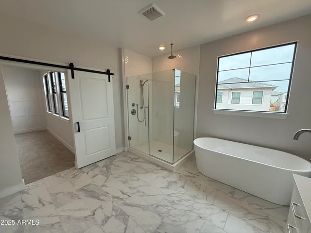 a bathroom with a tub shower and toilet