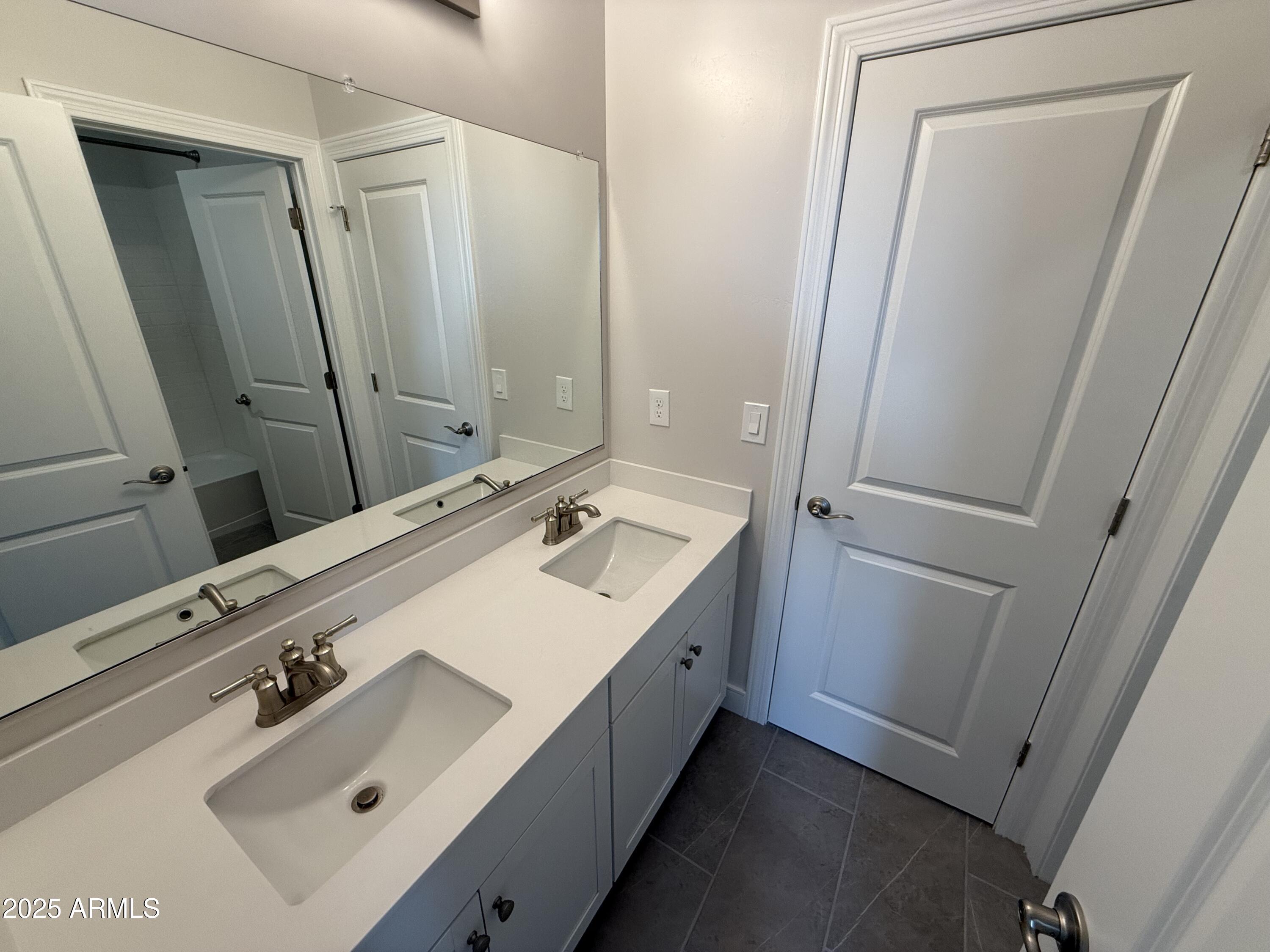 2430 West Los Arboles Place Chandler, AZ 85224 - Photo 34 of 41 a bathroom with a sink a mirror and a bathtub