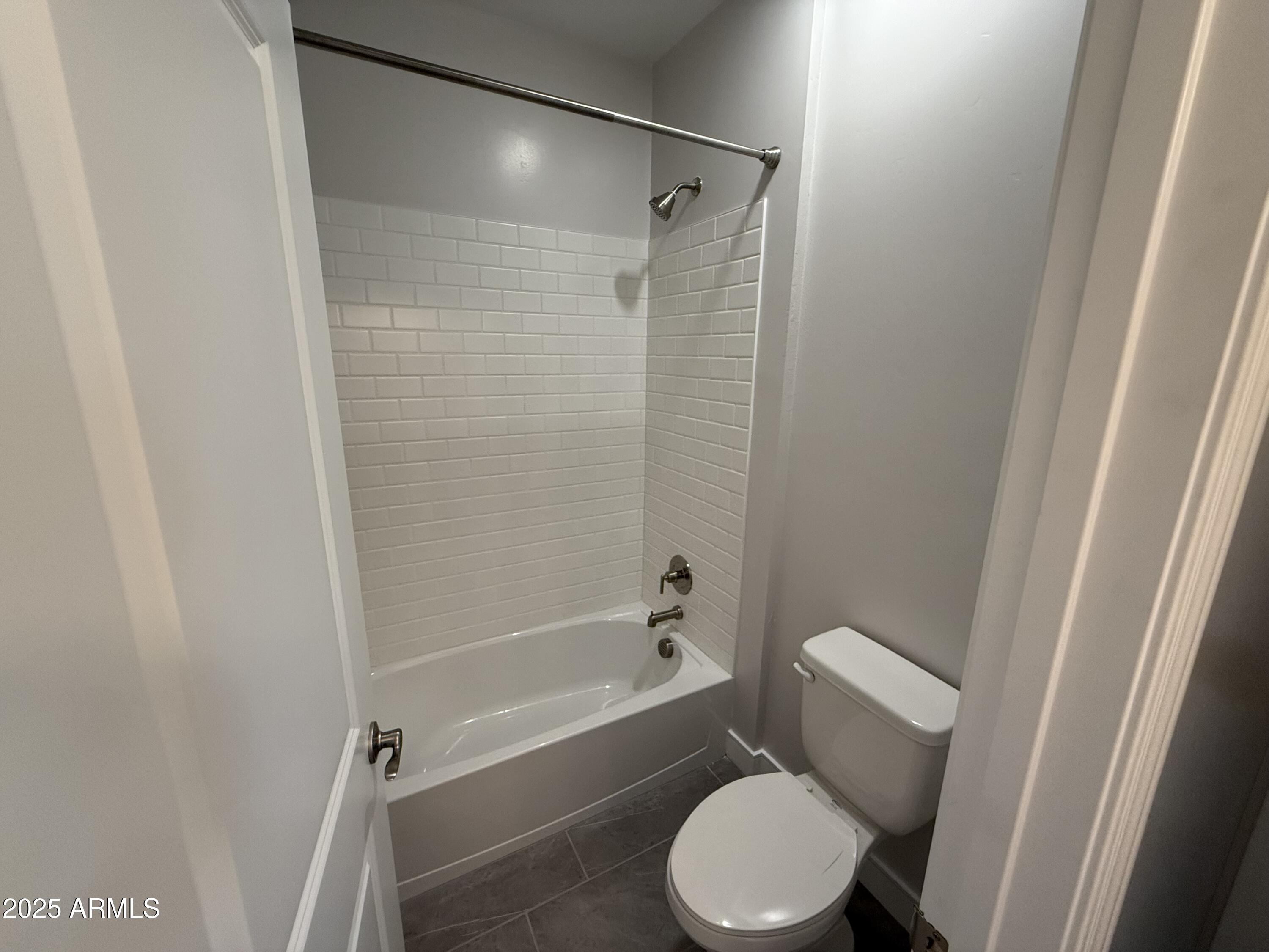 2430 West Los Arboles Place Chandler, AZ 85224 - Photo 35 of 41 a white toilet and tub next to a window