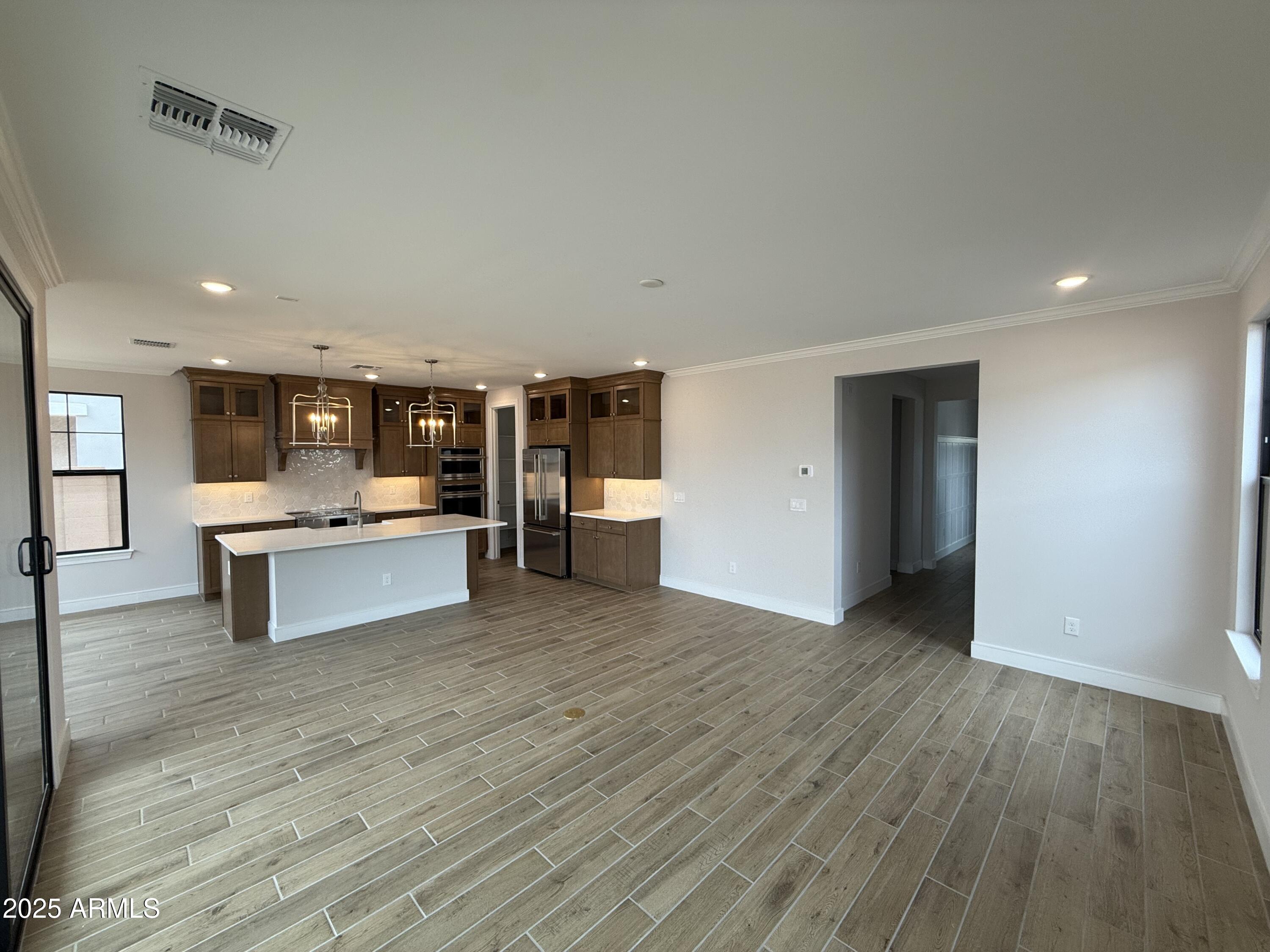 2430 West Los Arboles Place Chandler, AZ 85224 - Photo 3 of 41 a view of kitchen with wooden floor