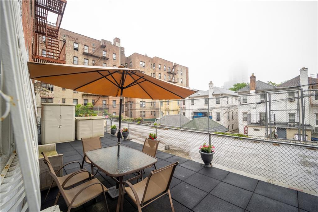 1625 Emmons Avenue, Unit 1R Brooklyn, NY 11235 - Photo 18 of 25 a view of a patio with a table and chairs under an umbrella