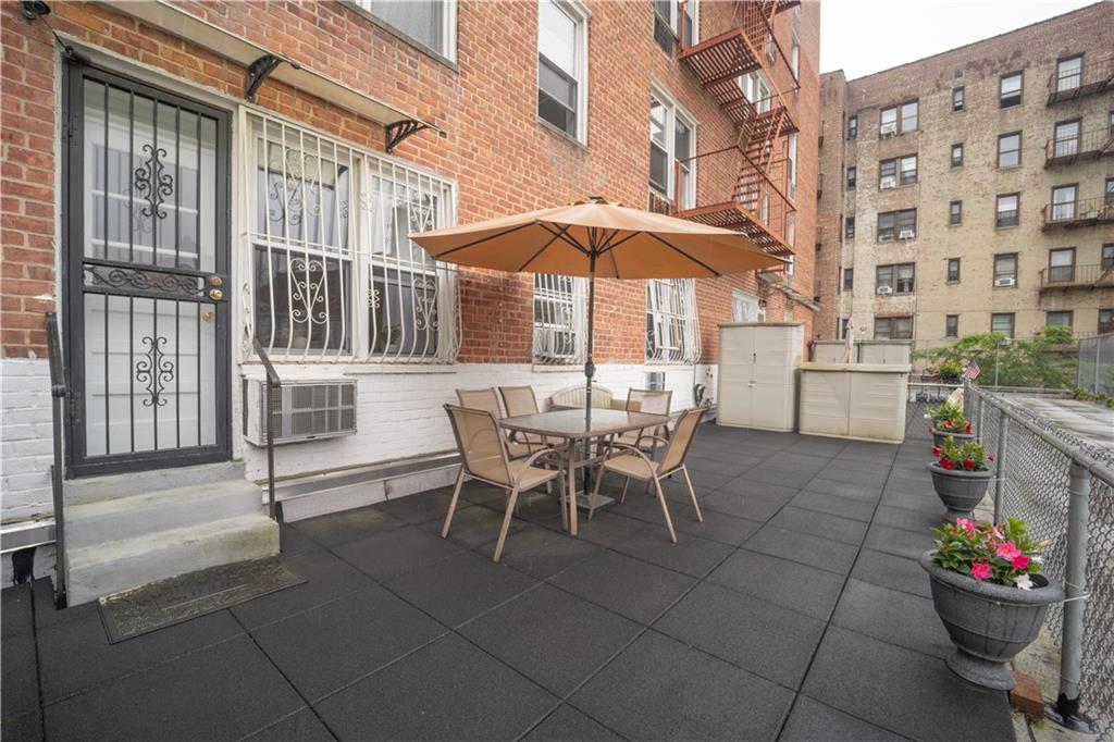 1625 Emmons Avenue, Unit 1R Brooklyn, NY 11235 - Photo 19 of 25 a view of a patio with a table and chairs and potted plants