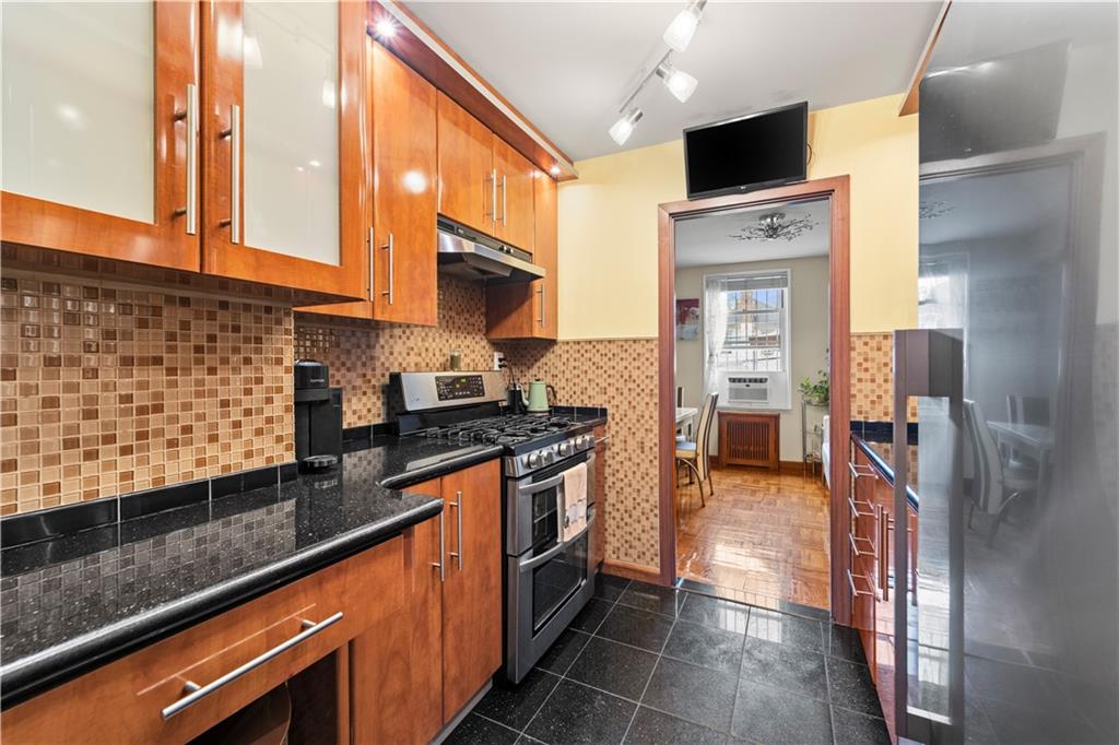 1625 Emmons Avenue, Unit 1R Brooklyn, NY 11235 - Photo 3 of 25 a kitchen with stainless steel appliances granite countertop a stove a sink and a microwave