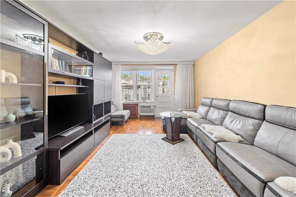 1625 Emmons Avenue, Unit 1R Brooklyn, NY 11235 - Photo 5 of 25 a living room with furniture tv and a flat screen tv