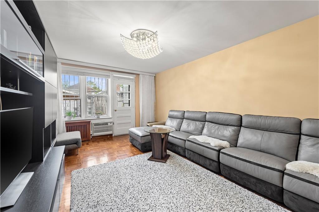 1625 Emmons Avenue, Unit 1R Brooklyn, NY 11235 - Photo 6 of 25 a living room with furniture and a large window