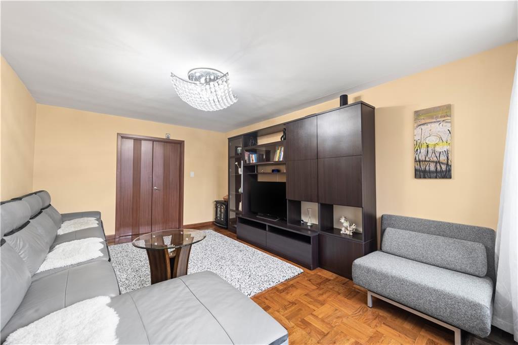 1625 Emmons Avenue, Unit 1R Brooklyn, NY 11235 - Photo 7 of 25 a living room with furniture and a flat screen tv