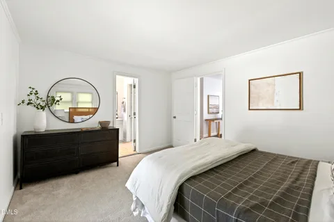 a bedroom with a bed and a mirror