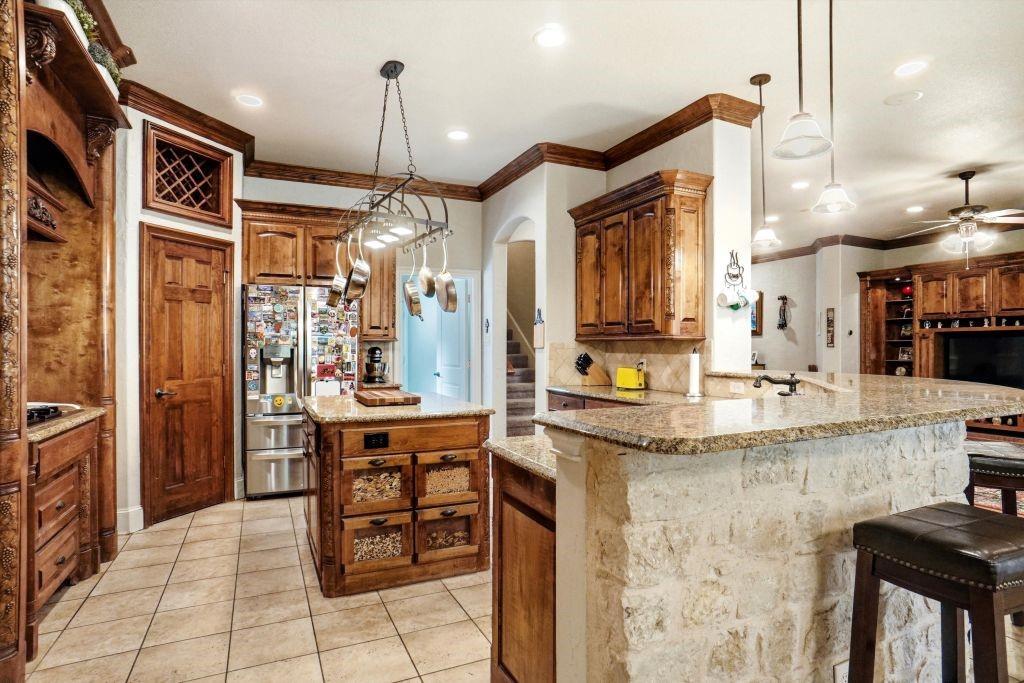 620 Highview Lane Hurst, TX 76054 - Photo 20 of 40 a kitchen with stainless steel appliances granite countertop a stove a sink and a refrigerator