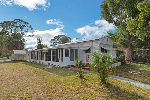 a view of a house with backyard porch and sitting area